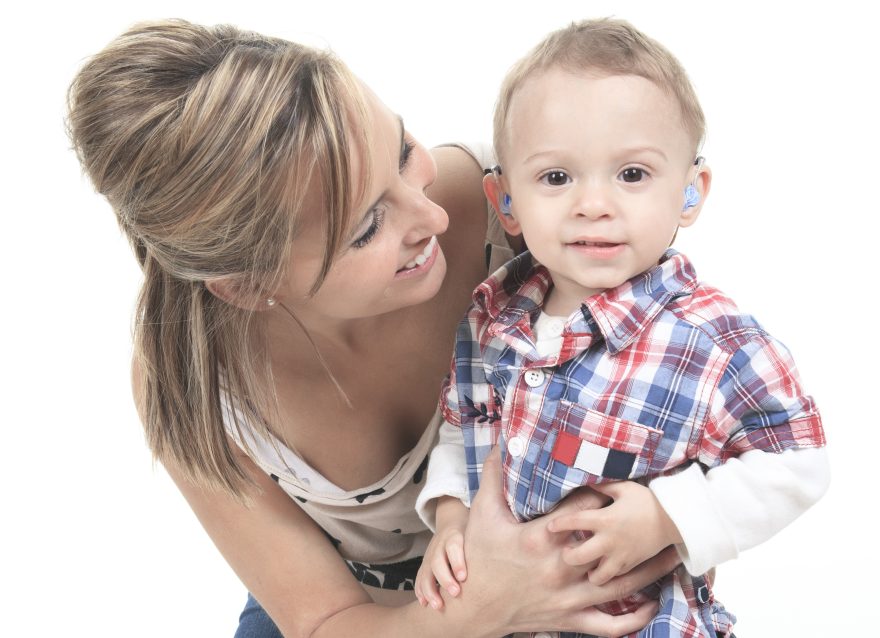 Mother with son. The kid have a Hearing Aids.